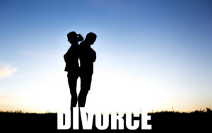 Silhouette of couple facing opposite directions with sky background