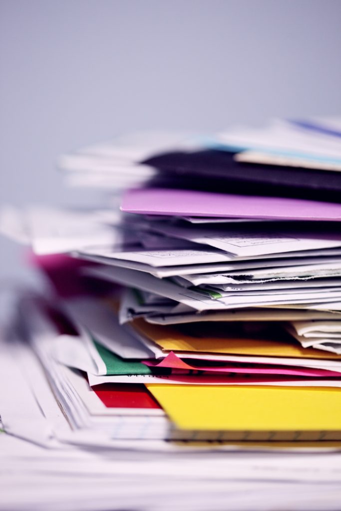 Papers and Colorful Files in Loose stack piled on a desk or table